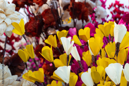 Colorful artificial flowers made out of colored sola, spongewood, handicrafts on display during the Handicraft Fair in Kolkata , West Bengal, India. It is the biggest handicrafts fair in Asia. photo
