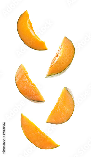 Flying slices of ripe melon isolated on white