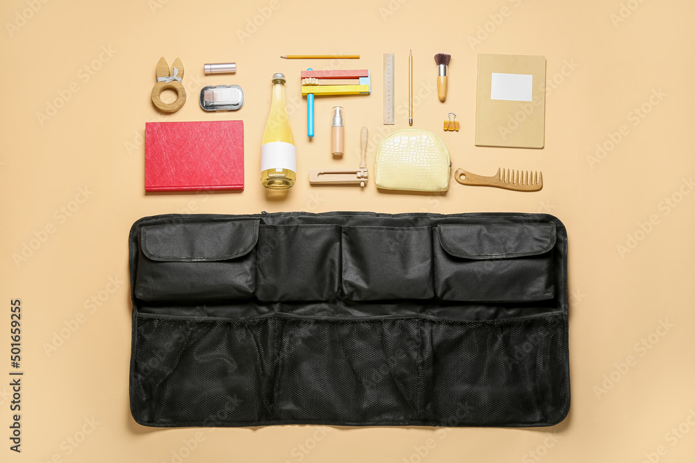 Composition with black travel organizer and different things on color background Composition with black travel organizer and different things on color background