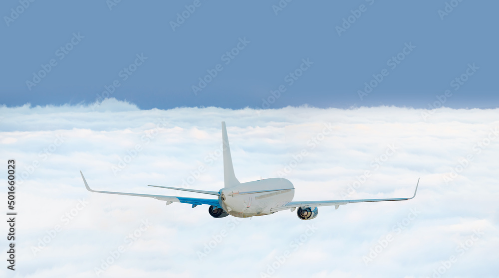Obraz premium White passenger airplane flying in the sky amazing clouds in the background - Travel by air transport