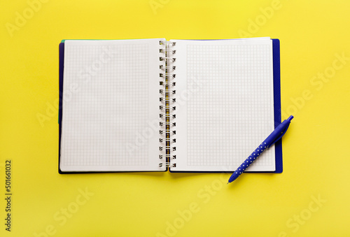 Notebook and pen on yellow ...