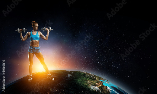 Young beautiful girl doing exercise against dark background