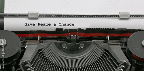 Ancient typewriter with the text Give Peace a Chance which is a message of hope and against violence