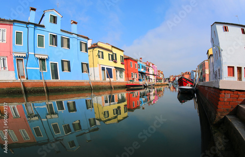 reflection on the water of the colorful houses on the island of Burano near Venice in Northern Italy in Europe