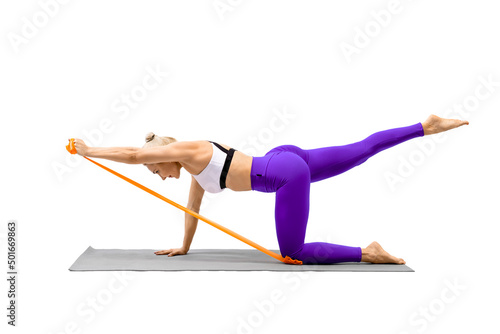 Arms workout with props. Caucasian attractive woman standing on all fours and training her shoulders using resistance band, isolated on white.
