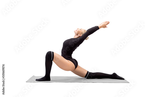 Beautiful fit sexy woman in black body and gaiters does Crescent Moon pose, Anjaneyasana, isolated on white.