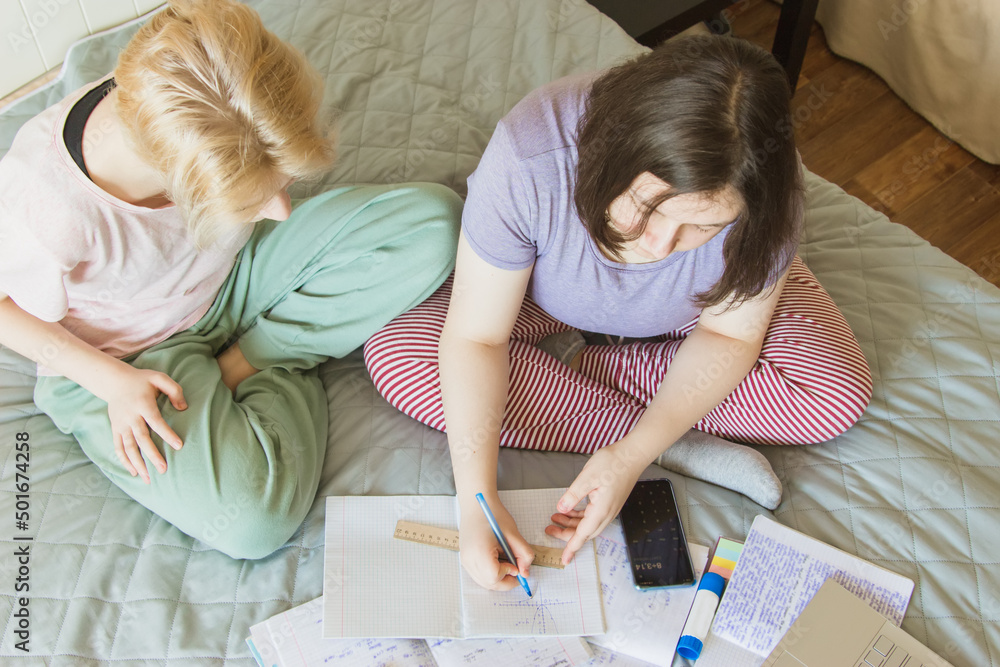 Education concept from above. Two gen z teenagers preparing exam. Education concept from above. Two gen z teenagers preparing exam.