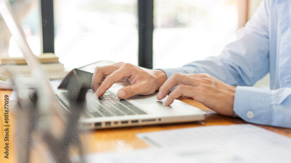 Business analyst concept the hands of businessman inserting the information of the products by using laptop Business analyst concept the hands of businessman inserting the information of the products by using laptop