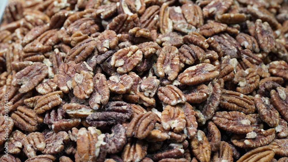 Raw English walnut nuts for sale at local city market. Pile of peeled English walnut. Natural background Raw English walnut nuts for sale at local city market. Pile of peeled English walnut. Natural background