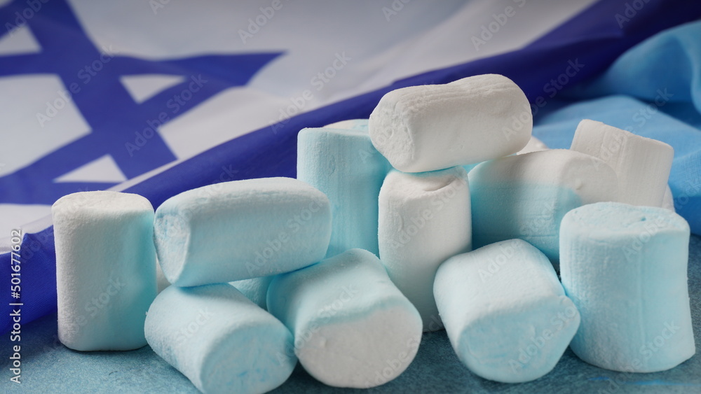 Fototapeta premium Israel national flag and marshmallows. Concept of Independence day Israel - Yom Ha`atzmaut.