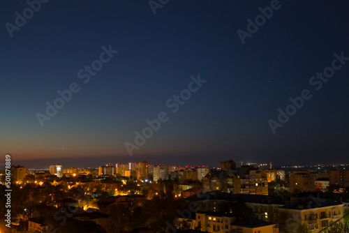 Color photograph of the parade of planets in the night sky. Jupiter, Venus, Mars, Saturn before sunrise. Beautiful clear predawn sky above the city.