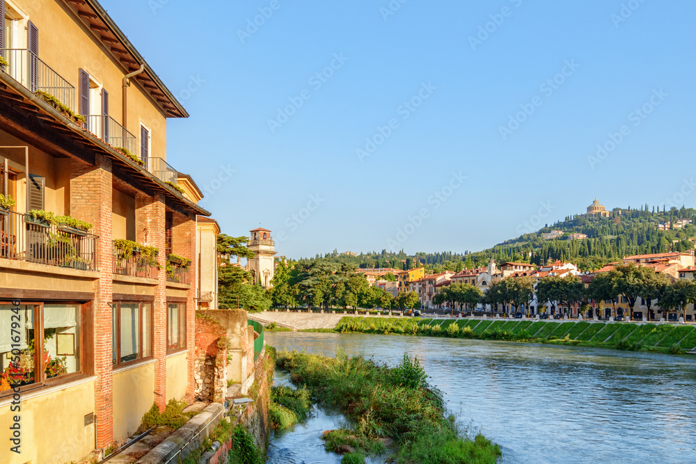 Facade of old house on waterfront of the Adige River, Verona