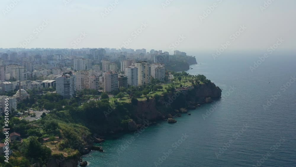 aerial drone revealing the skyline of Antalya Turkey on a summer afternoon with large cliffs surrounded by the Mediterranean Sea aerial drone revealing the skyline of Antalya Turkey on a summer afternoon with large cliffs surrounded by the Mediterranean Sea