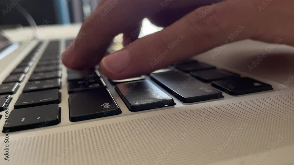 Typing on keyboard. Male hand fingers pressing button key on English - Thai laptop keyboard. Work from home professional hand typing close up shot - technology concept Typing on keyboard. Male hand fingers pressing button key on English - Thai laptop keyboard. Work from home professional hand typing close up shot - technology concept