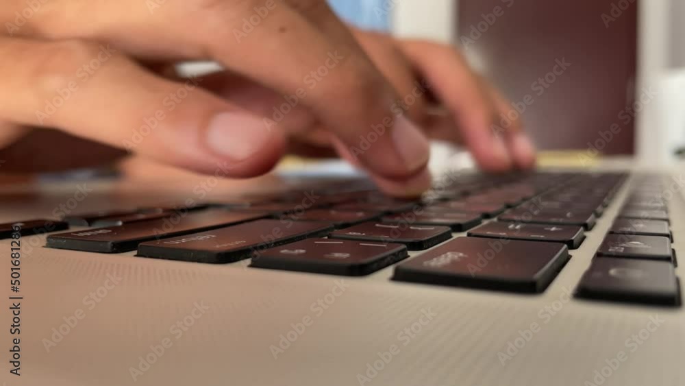 Typing on keyboard. Male hand fingers pressing button key on English - Thai laptop keyboard. Work from home professional hand typing close up shot - technology concept Typing on keyboard. Male hand fingers pressing button key on English - Thai laptop keyboard. Work from home professional hand typing close up shot - technology concept