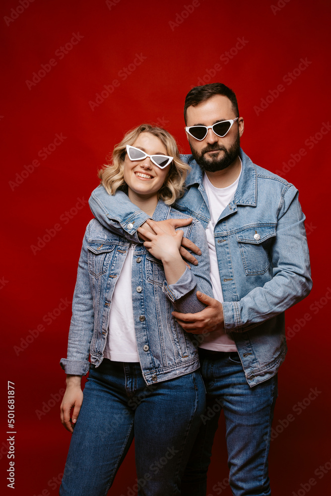 couple wearing sunglasses, happy couple on red background. couple wearing sunglasses, happy couple on red background.