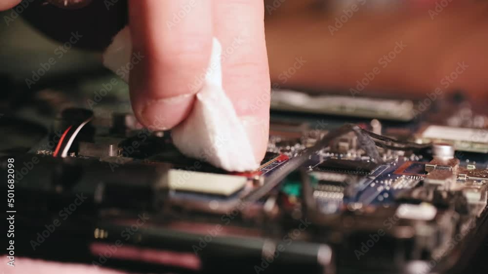 Laptop cooling system repair disconnecting the cable and removing the cooling cooler, close-up Laptop cooling system repair disconnecting the cable and removing the cooling cooler, close-up