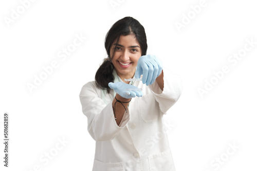 Young Venezuelan female orthodontist holding invisible dental aligners. Isolated over white background.