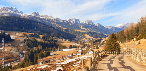 Panorama of Dolomites mountains and the city of Moena. View from above. photo