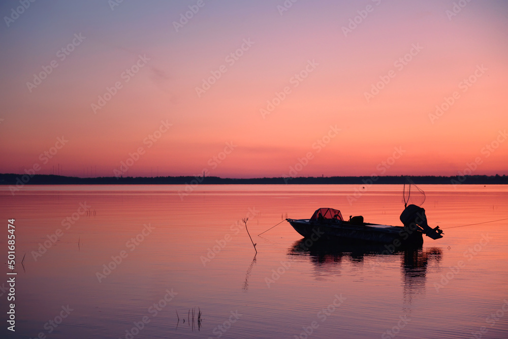 The fishing boat with equipment is preparing for the sea for night fishing. The concept of sports fishing, tourism and rest. Soft focus, night fishing, copy space