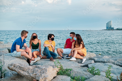 group of young people at sunset in Barcleona Beach photo