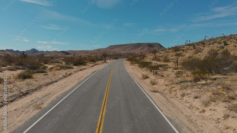 Desert road Joshua Tree establishing fly up 4k drone shot. Desert road Joshua Tree establishing fly up 4k drone shot.