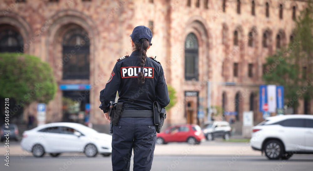 Caucasian female police officer in the city. Caucasian female police officer in the city.