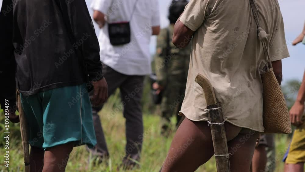 Triba local people in South Asia meeting outdoor unrecognizable faces carring machete Triba local people in South Asia meeting outdoor unrecognizable faces carring machete