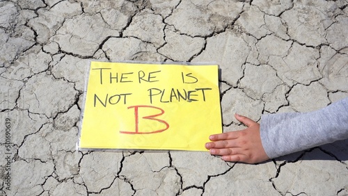 sign with There is not Planet B , Save the Planet in arid land deserted due to lack of water and drought , environmental protest against climate change, global warming 