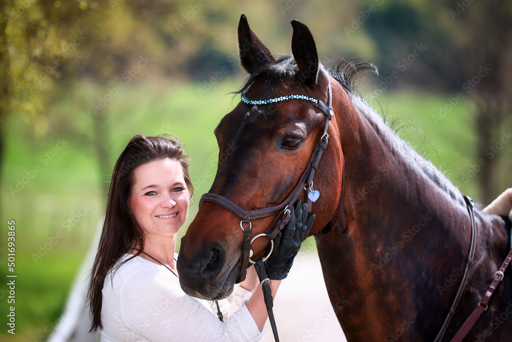 Fototapeta premium Woman in head portraits with horse, smiling looking at the camera..
