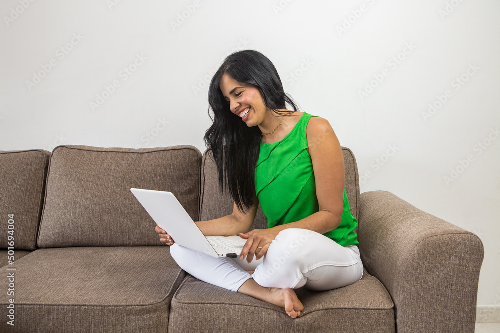 Hispanic woman watching funny video on laptop Hispanic woman watching funny video on laptop