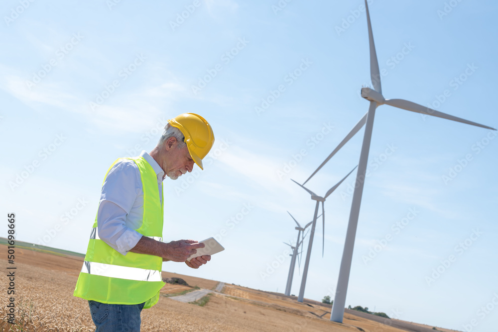 Engineer using digital tablet for wind turbine inspection Engineer using digital tablet for wind turbine inspection