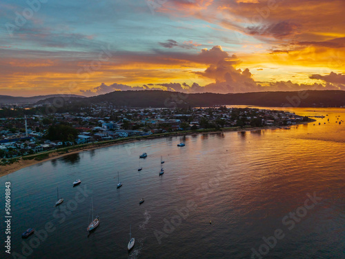 Aerial sunrise waterscape with boats, colour and clouds
