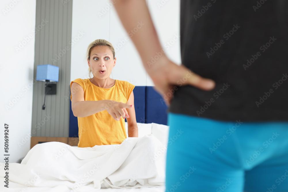 Finger Getting Zapped Shocked woman pointing finger at man in shorts Stock Photo | Adobe Stock