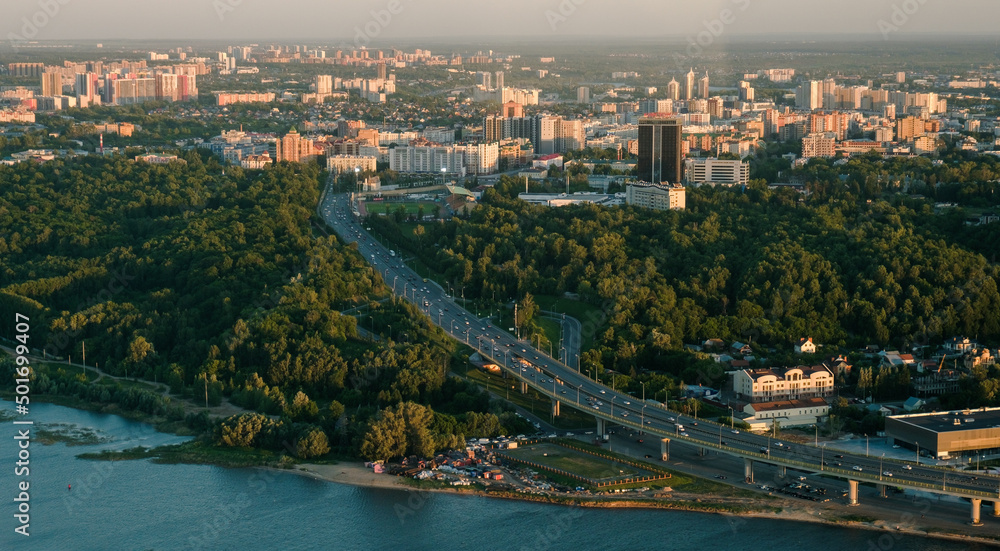 Fototapeta premium Summer shot from above of Kazan city. Capital of the Tatarstan, Russia. City centre and landmark. Bridge and attractions. Torism and tourist destination. Gorky park. Trees and vacation in the city.