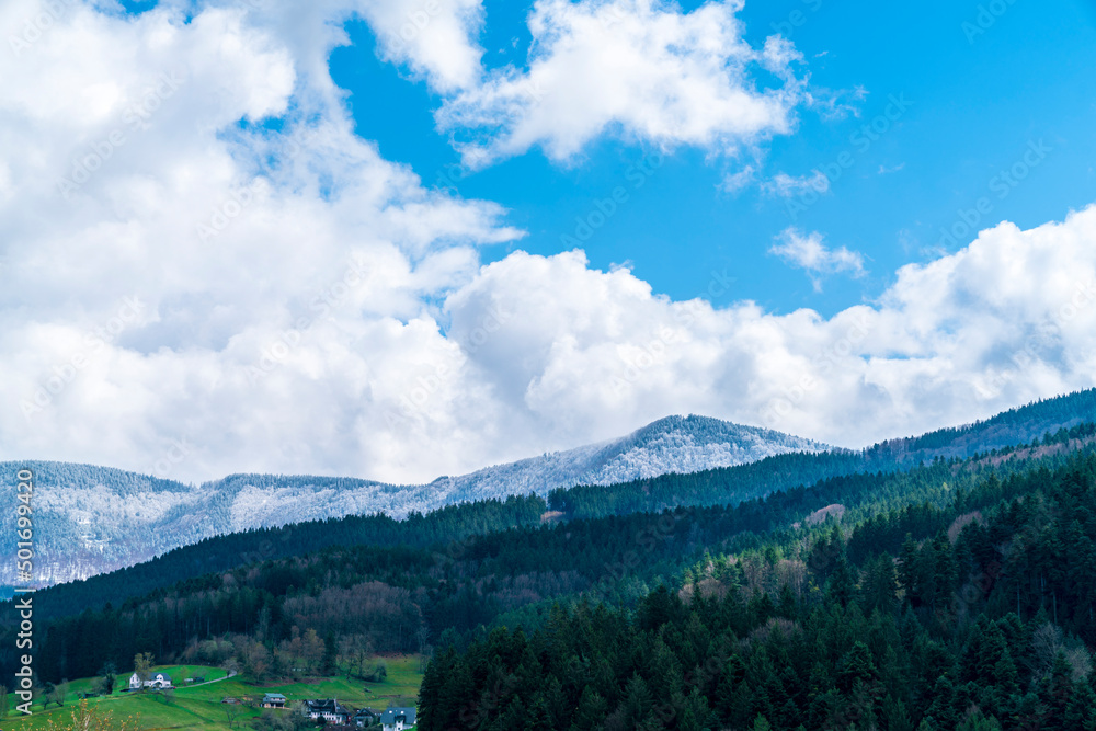 Germany, Magical black forest panorama view above beautiful nature landscape in springtime, snow covered mountains