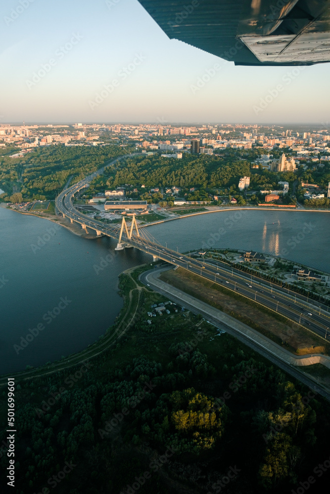 Summer shot from above of Kazan city. Capital of the Tatarstan, Russia. City centre and landmark. Bridge Millenium. Tourism and tourist destination. Gorky park. Trees and vacation in the city.
