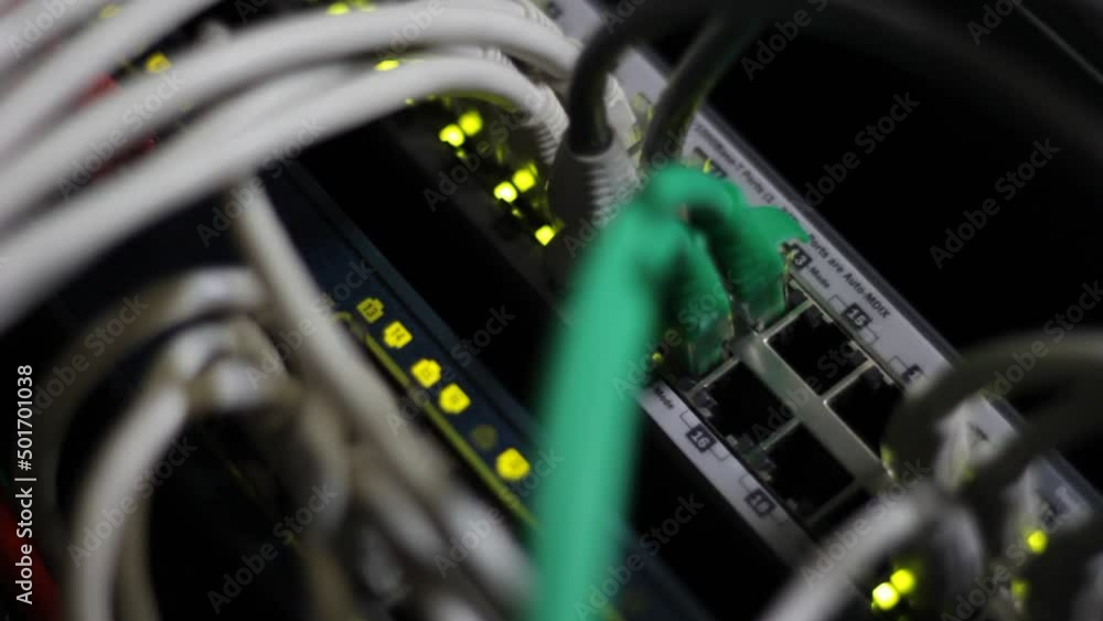 Working switch in data center. UTP cables, jacks, blinking led