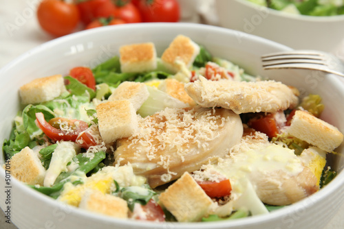 Delicious Caesar salad in bowl, closeup view