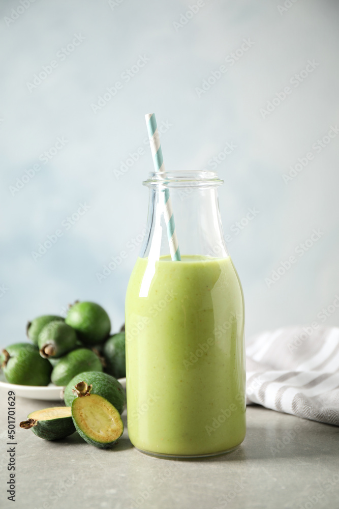Fresh feijoa smoothie and fresh fruits on grey table Fresh feijoa smoothie and fresh fruits on grey table