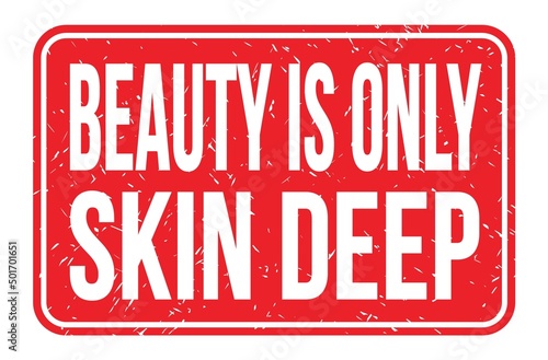 BEAUTY IS ONLY SKIN DEEP, words on red rectangle stamp sign