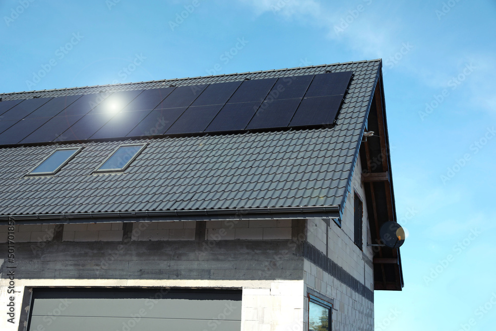 House with installed solar panels on roof. Alternative energy House with installed solar panels on roof. Alternative energy