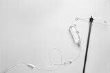 IV infusion set on light grey background, flat lay. Space for text
