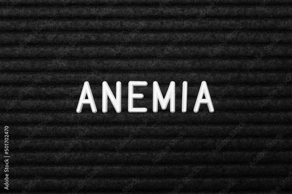 Word Anemia on black fabric, flat lay Word Anemia on black fabric, flat lay