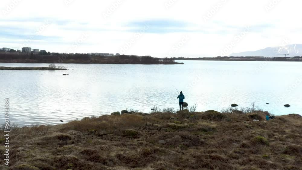 Icelandic fisherman at the rocky autumn water in nature outside the city aerial Drone footage Icelandic fisherman at the rocky autumn water in nature outside the city aerial Drone footage