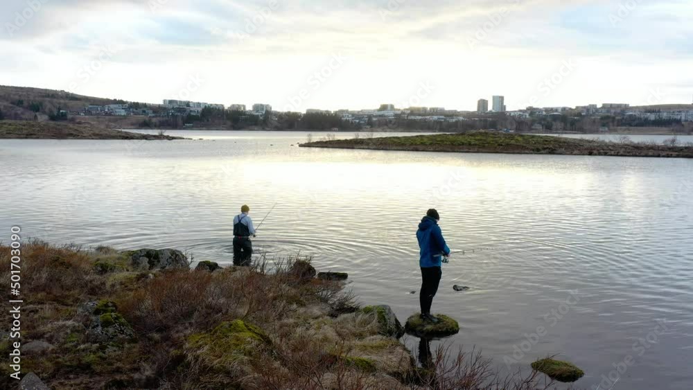 Two fishermen fishing for dinner in the autumn afternoon nature cloudy sun outside the city limits Two fishermen fishing for dinner in the autumn afternoon nature cloudy sun outside the city limits