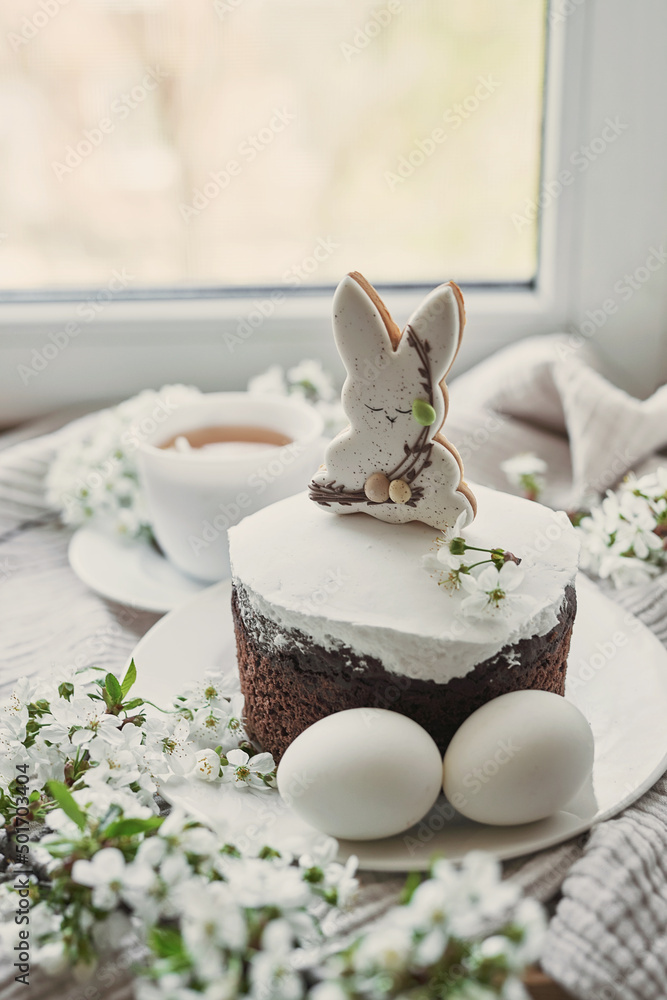 Celebration and holiday. Easter cake with gingerbread, homemade cake, eggs. Easter bunny and flowering branches postcard Celebration and holiday. Easter cake with gingerbread, homemade cake, eggs. Easter bunny and flowering branches postcard