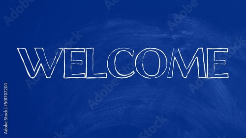 Welcome written on blue chalkboard