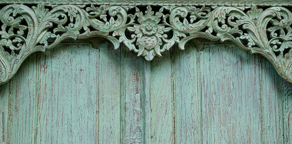 Carved wooden frame on door in Bali. Border texture