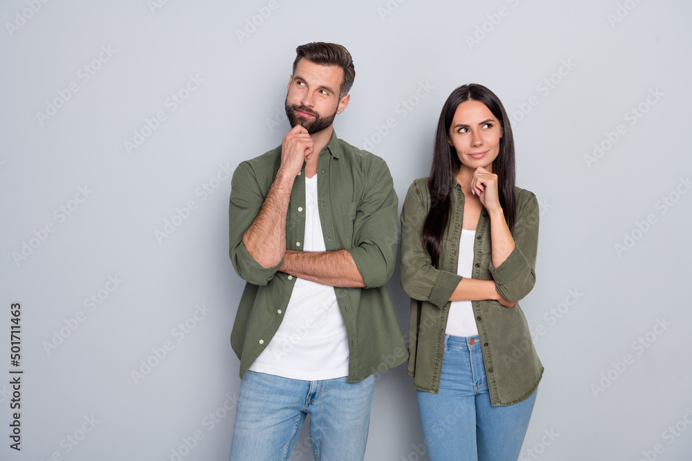 Photo of young husband wife think plan minded look empty space wonder trust isolated over grey color background Photo of young husband wife think plan minded look empty space wonder trust isolated over grey color background
